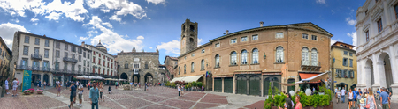 BERGAMO, ITALY - JULY 16, 2017: Tourists visit Bergamo Alta square, panoramic view. Bergamo is a major attraction in Italy.のeditorial素材