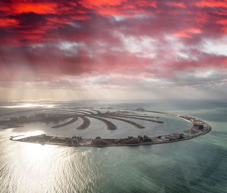 Amazing aerial view of Palm Jumeirah Island in Dubai from helicopter against sunset sky.のeditorial素材