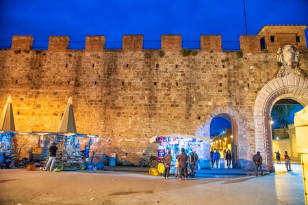 PISA, ITALY - APRIL 14, 2018: Entrance of Square of Miracles with tourists at night. Pisa is a medieval town of Tuscany.のeditorial素材