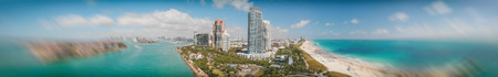 Panoramic aerial view of Miami Beach and South Pointe Park at dusk.