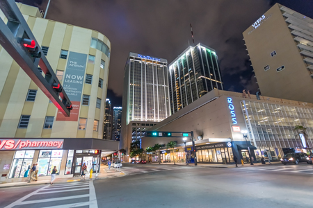 MIAMI - MARCH 27, 2018: Street view of Downtown buildings at night. Miami attracts 20 million...