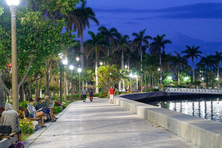 WEST PALM BEACH, FL - APRIL 9, 2018: Tourists and locals enjoy riverfront at night. The city is a...