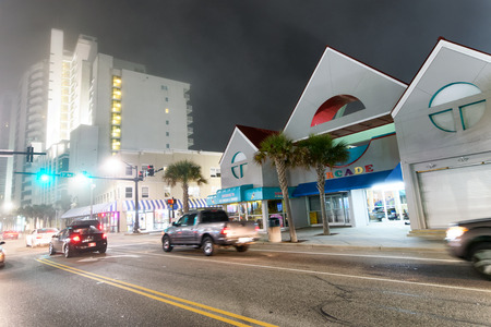MYRTLE BEACH, SC - APRIL 3, 2018: Tourists along the streets at night. Myrtle Beach attracts more than 15 million people annually.のeditorial素材