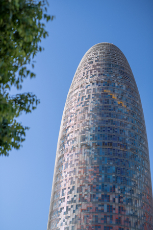 BARCELONA - MAY 14, 2018: Agbar Tower surrounded by trees. It is a major attraction in the city.のeditorial素材
