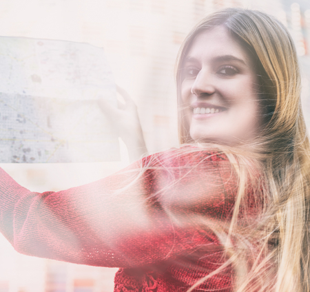 Beautiful blonde girl with city map and modern building on background.