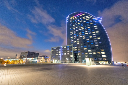 BARCELONA - MAY 10, 2018: W building and city skyline at night. The city attracts 10 million tourists annually.のeditorial素材