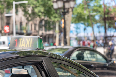BARCELONA - MAY 11, 2018: Taxis along city roads. Barcelona attracts 10 million tourists annually.のeditorial素材