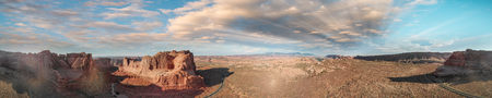 Panoramic sunset aerial view of Arches National Park from helicopter, Utah.