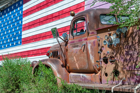 Old truck and american flag, symbol of US Route 66.