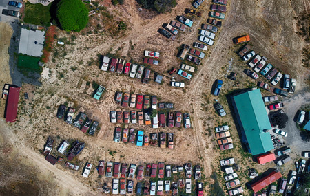 Overhead aerial view of cars wreckage gathered in a countryside parking.の写真素材