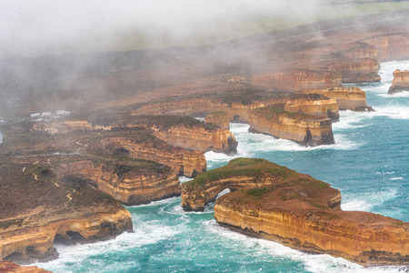 Loch Ard Gorge aerial view from helicopter with clouds and fog, Port Campbell, Australiaの写真素材