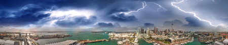 Auckland, New Zealand. Sunset aerial panorama of city skyline during a storm.