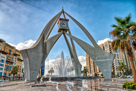 DUBAI, UAE - DECEMBER 10, 2016: City Clock Tower roundabout on a sunny day. Dubai attracts 20 million tourists annually.のeditorial素材