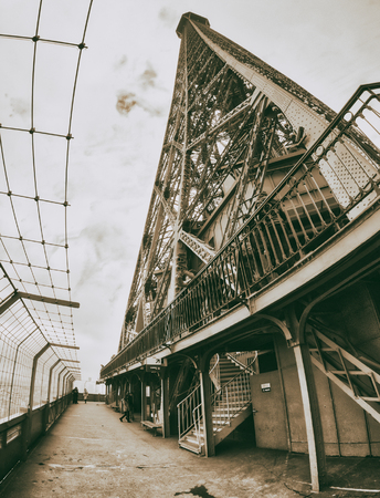 PARIS, FRANCE - DECEMBER 2012: Tourists visit Eiffel Tower, wide angle view. The city attracts 40 million people every year.のeditorial素材