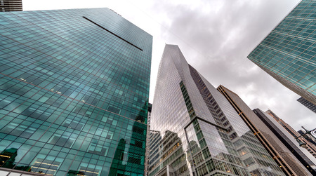 Modern skyscrapers of New York as seen from the street against a overcast sky.のeditorial素材