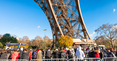 PARIS, FRANCE - DECEMBER 2012: Tourists visit Eiffel Tower. The city attracts 40 million people every year.のeditorial素材