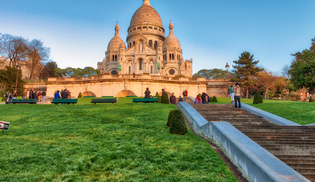 PARIS, FRANCE - DECEMBER 2012: Tourists visit Sacred Heart cathedral. The city attracts 40 million people every year.のeditorial素材