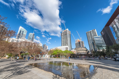 SYDNEY, AUSTRALIA - AUGUST 19, 2018: City skyscrapers from a beautiful park on a sunny day. Sydney attracts 15 million tourists annually.のeditorial素材
