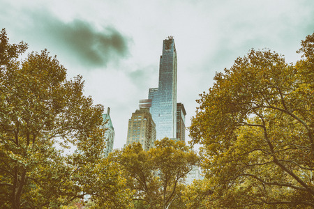 Skyscrapers and trees in Central Park, New York City in autumnの写真素材
