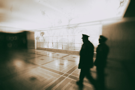 Police officers walking inside main station, blurred viewの写真素材