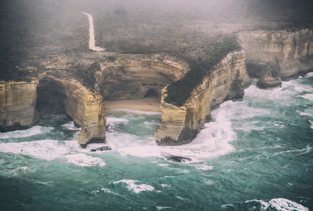 Aerial view of natural rock formations along Great Ocean Road on a stormy day, Australia.の写真素材