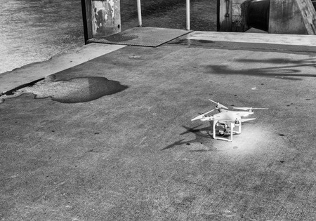 SYDNEY - OCTOBER 2015: Dji Phantom 3 Professional drone landing in Sydney Harbor Promenade at night....