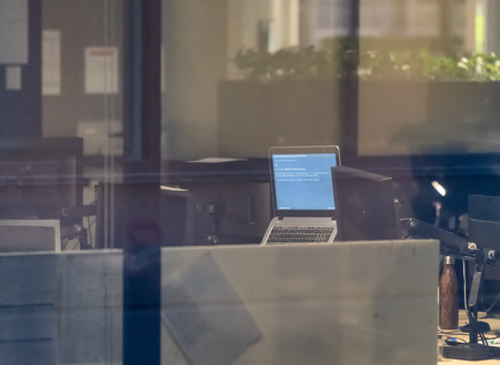 Interior of modern office as seen from outside through a window. Corporate and  technology concept.