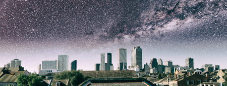 Starry night over New Orleans skyline. City buildings with milky way, Louisiana