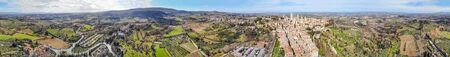 Panoramic aerial view of San Gimignano skyline at sunset, Tuscany.