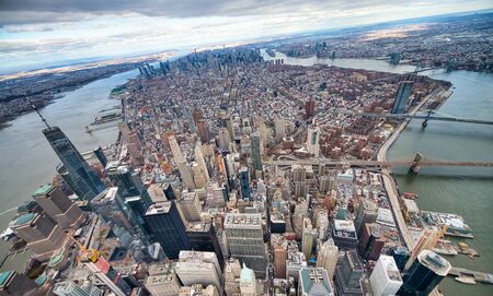 Wide angle aerial view of Downtown Manhattan, Brooklyn and Manhattan Bridges from helicopter, New...
