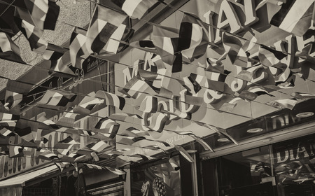 DUBAI - DECEMBER 2016: United Emirates flag in Dubai Market. The city attracts 15 million people annually.の写真素材