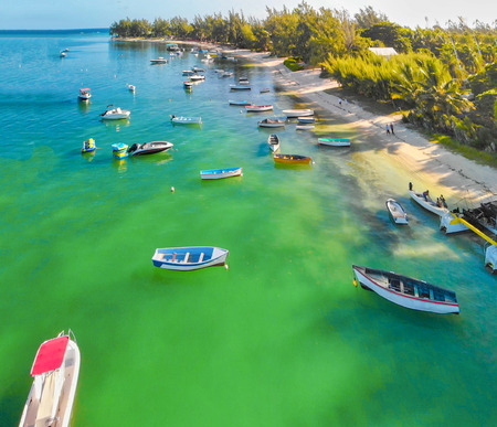 Beautiful turquoise ocean water with wooden boats on the water. Top view aerial photo.の写真素材