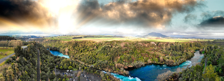 Huka Falls, New Zealand. Panoramic aerial view of beautiful waterfalls and countryside at sunset.の写真素材