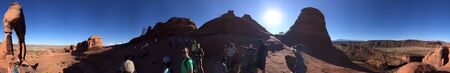 ARCHES NP, UT - JULY 2, 2019: Panoramic view of Delicate Arch with tourists.