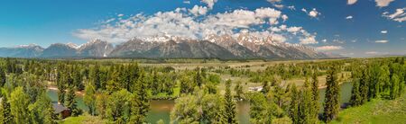 Panoramic aerial view of Grand Teton peaks, landscape and Snake River on a beautiful summer day,...