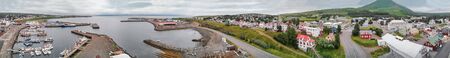 Panoramic sunset aerial view of Husavik port in Northern Iceland, the city is famous for whales...
