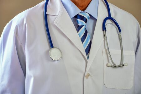 Front view of doctor chest with white dress. Confident position and posture. Healthcare abstractの写真素材