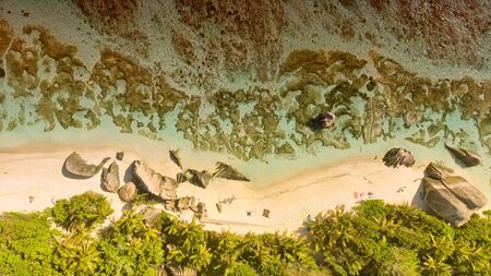 Overhead aerial view of beautiful Seychelles Beach and mountains in La Digue.