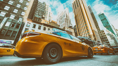 NEW YORK CITY - NOVEMBER 30, 2018: Yellow taxi cabs and city traffic along main avenue.のeditorial素材