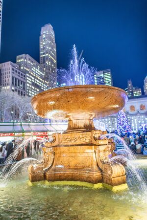 Fountain of Bryant Park at night in winter, New York City.の写真素材