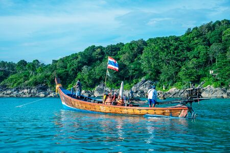 PHUKET, THAILAND - DECEMBER 17, 2019: Tourists on the wooden boat in the beautiful Freedom Beach.のeditorial素材