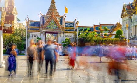Blurred view of moving tourists visiting Grand Palace in Bangkok, Thailand.のeditorial素材
