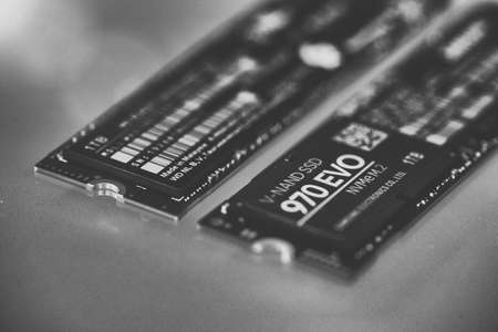 PISA, ITALY - FEBRUARY 12, 2020: NVME M2 SSD disks for data storage at high speed closeup on isolated backgroundのeditorial素材