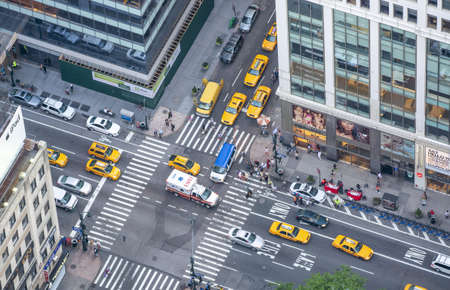 NEW YORK CITY - JUNE 2013: Aerial view of yellow cabs traffic along major avenue on a summer day.