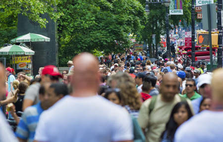NEW YORK CITY - JUNE 2013: Crowded Fifth Avenue on a summe day. Tourists and locals walking along the street.のeditorial素材
