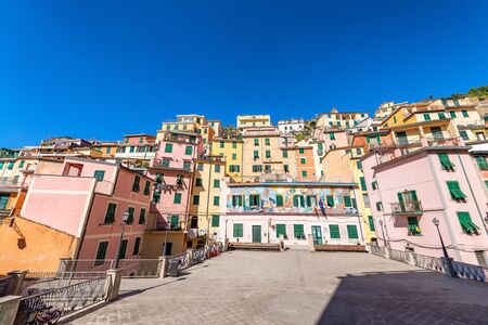 RIOMAGGIORE, ITALY - OCTOBER 2014: Colorful homes on a sunny day.