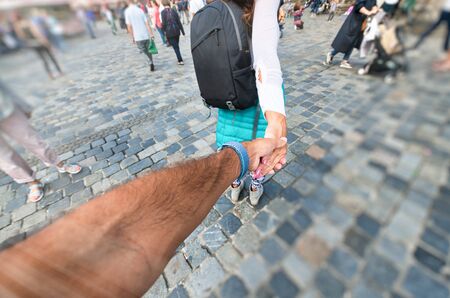 Woman tourist in color dress and backpack leading man to visit the city. Traveling together. Follow me
.の写真素材