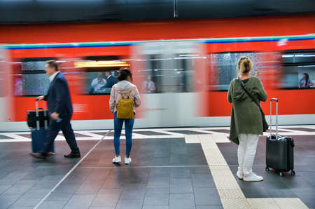FRANKFURT, GERMANY - SEPTEMBER 12, 2019: Train speeds up in subway train station.のeditorial素材