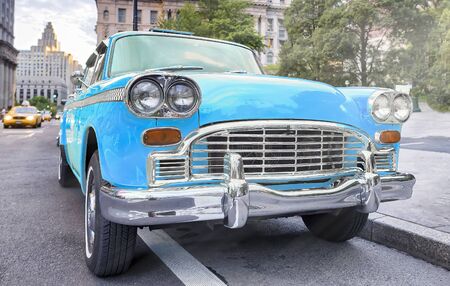 Vintage chequered blue taxi cab in New York City. Manhattan street traffic.の写真素材