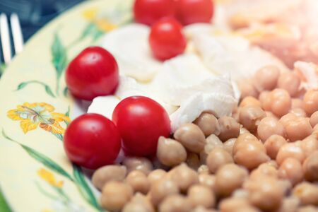 Fresh salad with mozzarella, tomatoes and chickpeas.の写真素材